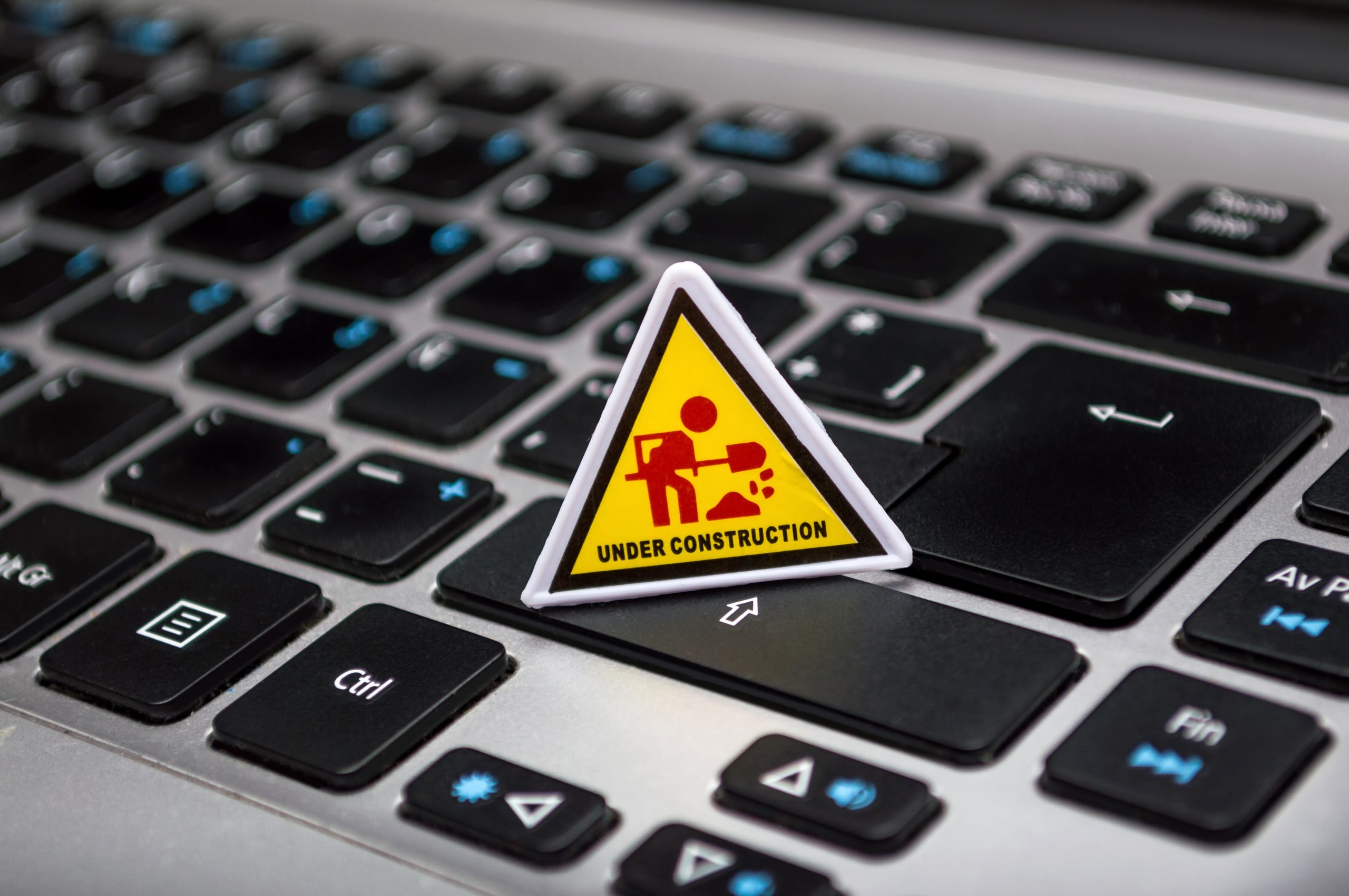 under-construction-signage-on-laptop-keyboard-211122 under-construction-signage-on-laptop-keyboard-211122