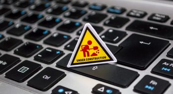 under-construction-signage-on-laptop-keyboard-211122 under-construction-signage-on-laptop-keyboard-211122